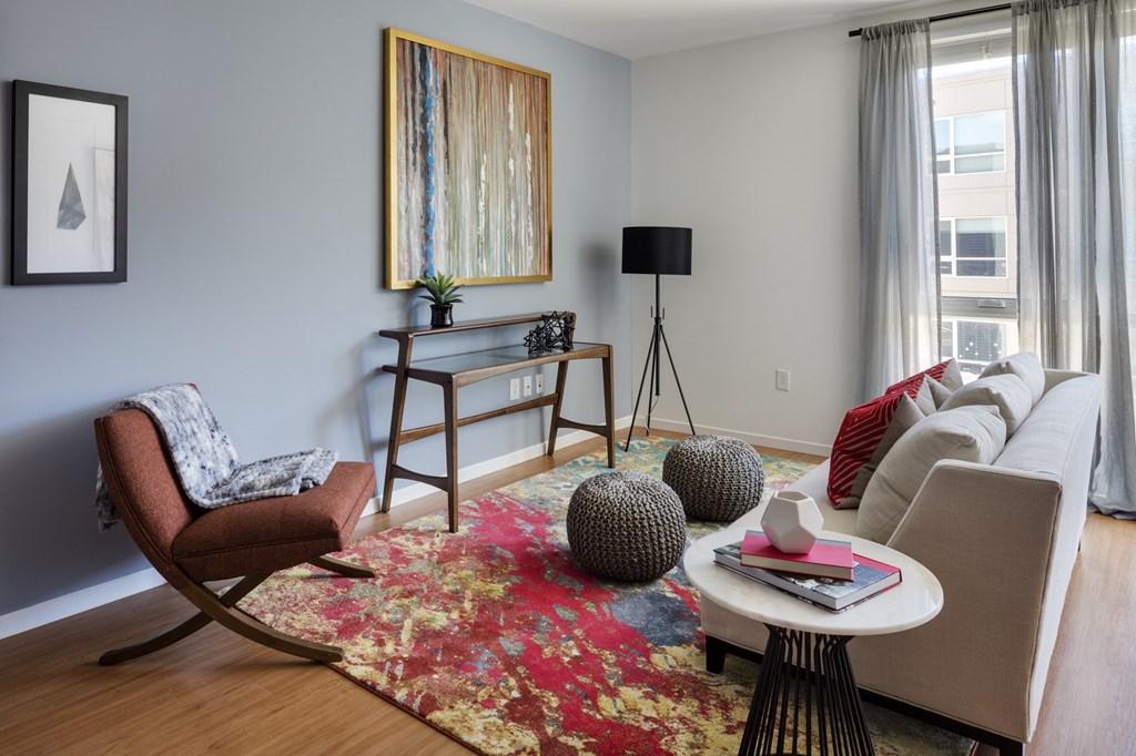 a living room with a couch and chairs and a coffee table